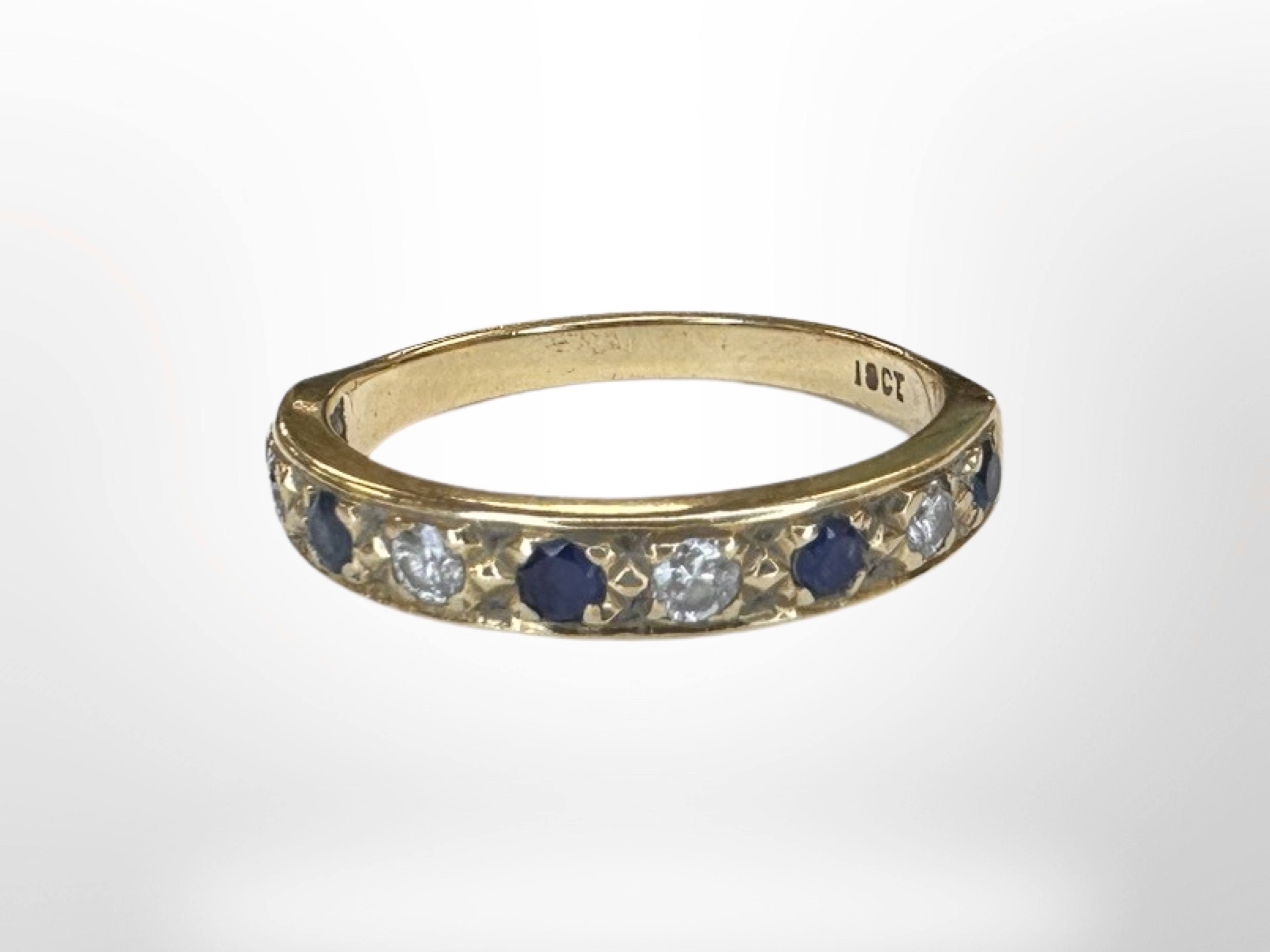 An 18ct gold diamond and sapphire half eternity ring, size O. CONDITION REPORT: 3.2g.