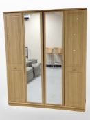 A contemporary oak effect mirror door wardrobe,