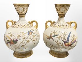 A pair of Royal Worcester gilt and hand-painted porcelain twin-handled vases decorated with