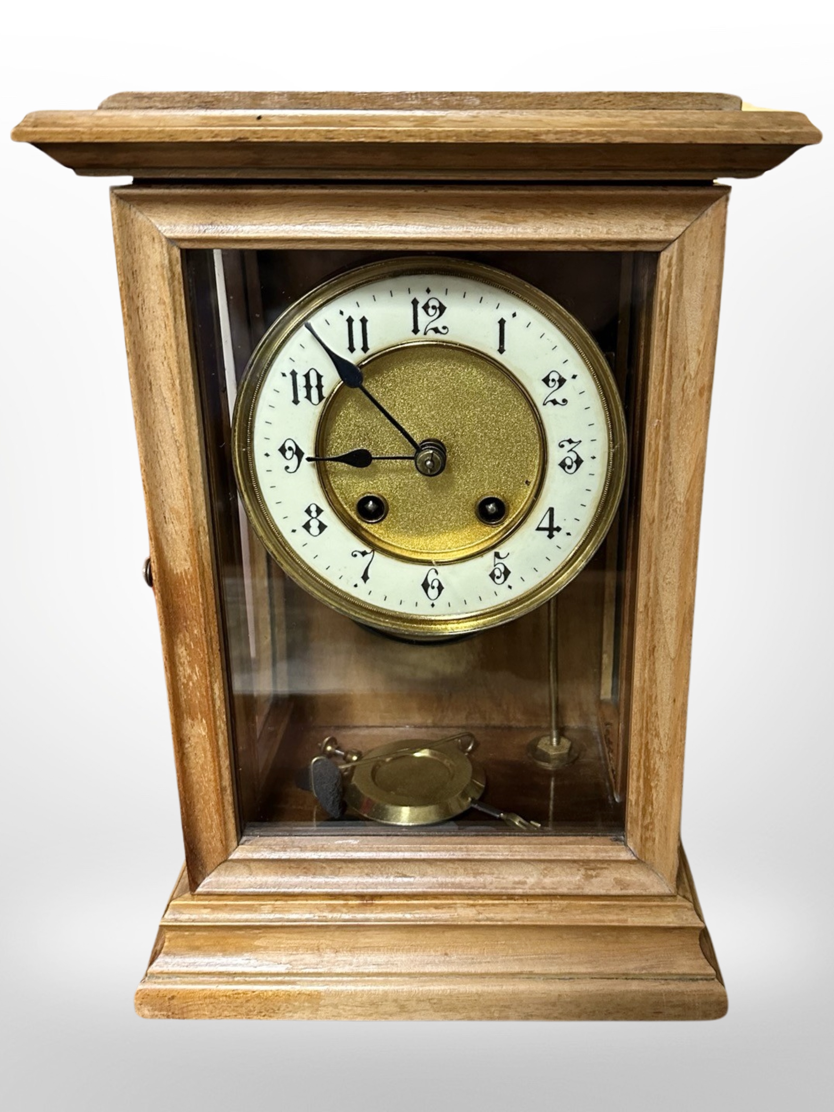 A beech-cased eight day mantel clock with enameled dial, height 30cm.