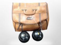 A leather bag containing Pinkmaster lawn bowls.