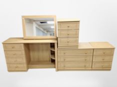 A contemporary oak effect dressing table with mirror back, matching low chest,