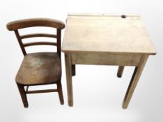 An early 20th century child's pine school desk with chair