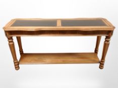 A contemporary teak glass topped side table,