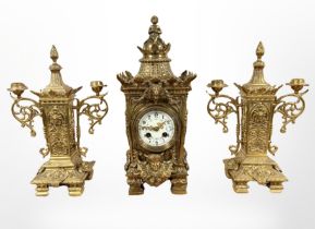 An impressive 19th century gilt metal clock garniture, striking on a gong, with pendulum and key,