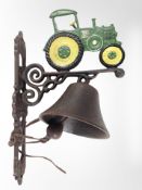 A cast-iron tractor wall-mounted bell on bracket, length from wall 23cm.