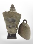A Thai patinated bust of Buddha, height 31cm, and a further temple bell.