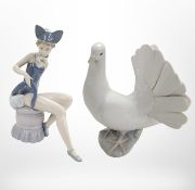 A Lladró figure of a seated girl wearing a cat costume and a further figure of a dove.