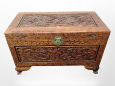 An oriental heavily carved camphor wood chest,