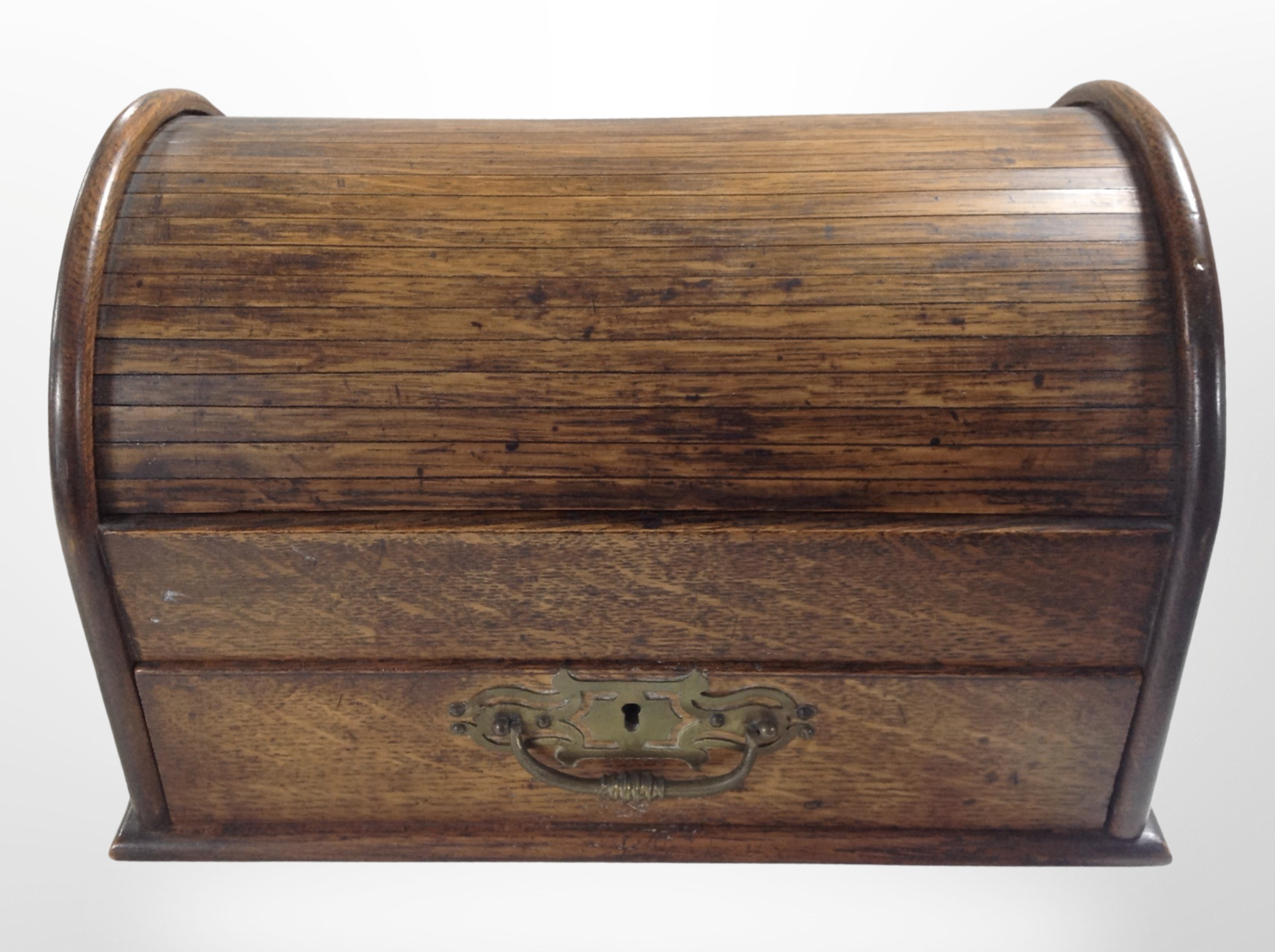 A 19th-century oak roll top table in box, fitted a drawer, width 32cm.