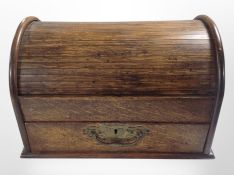 A 19th-century oak roll top table in box, fitted a drawer, width 32cm.