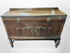 An early 20th century oak linen fold sideboard,