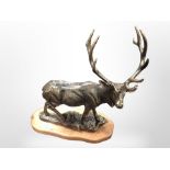 A cast-iron stag on wooden plinth, height 46cm.