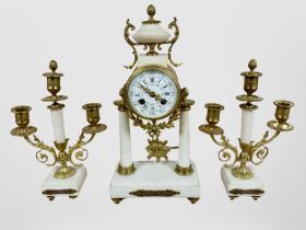 A 19th century French white marble and gilt metal portico clock garniture, striking on a bell,