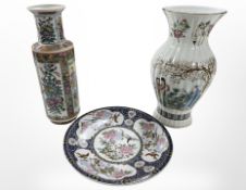 Two contemporary oriental porcelain vases, tallest 36cm, and a further charger.