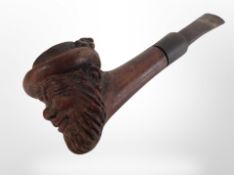 An antique pipe, the bowl carved as a bearded man, length 15cm.