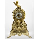 A 19th century Rococo Revival gilt metal eight day mantel clock, surmounted by a cherub,