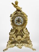 A 19th century Rococo Revival gilt metal eight day mantel clock, surmounted by a cherub,