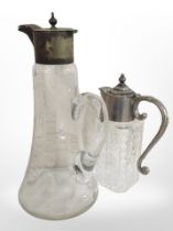 Two crystal claret jugs with silver-plated lids, tallest 28cm.