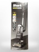 A Shark corded upright vacuum cleaner in box