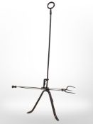 A 19th-century steel toasting fork on tripod stand, height 87cm.