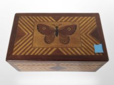 A parquetry box decorated with a butterfly, width 19cm.