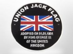 A cast-iron Union Jack plaque, diameter 25cm.