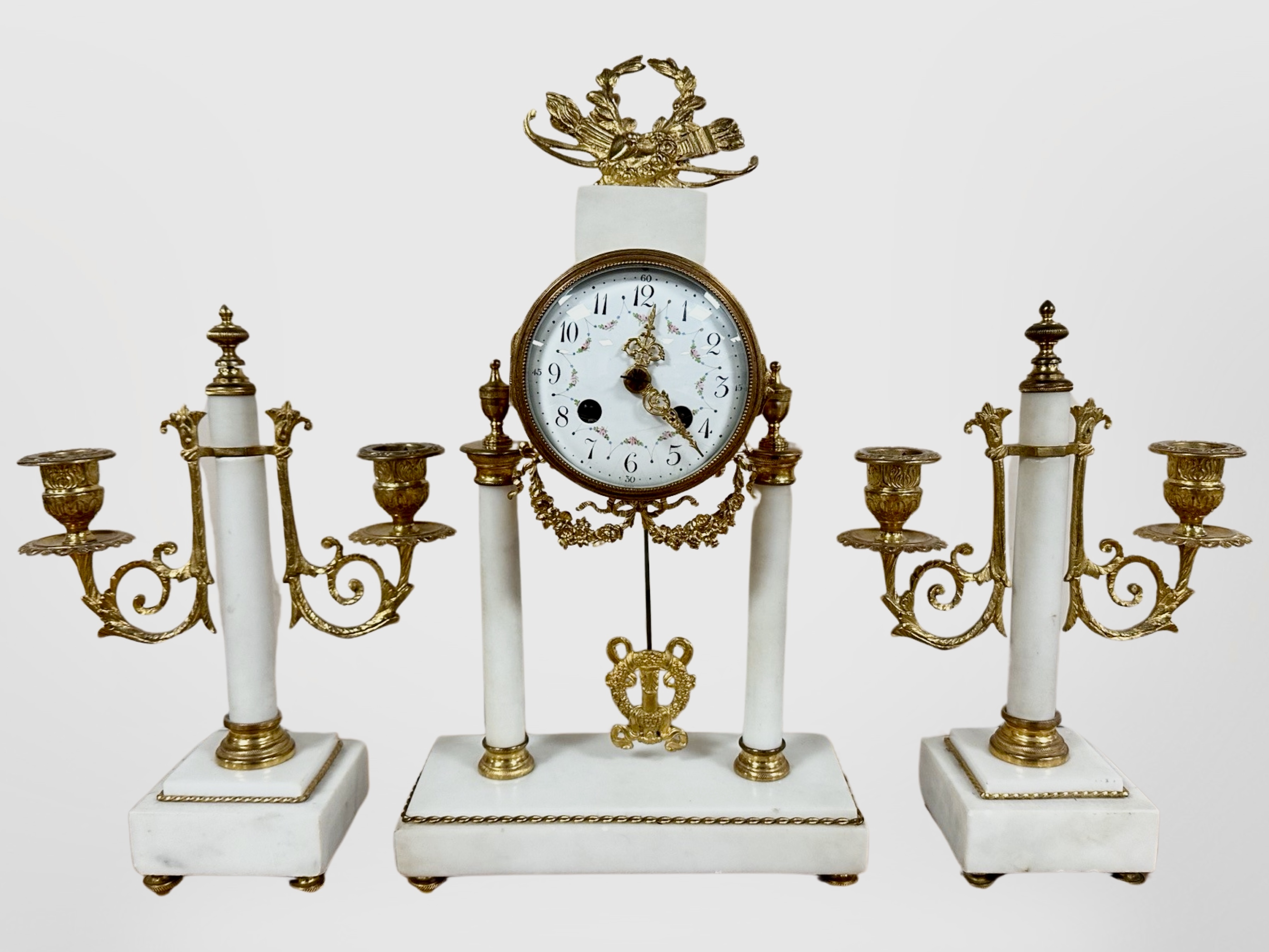 A 19th century French white marble and gilt metal portico clock garniture, striking on a bell,