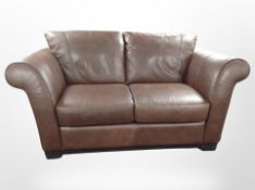 A brown stitch leather two seater settee,