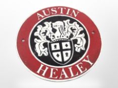 A cast-iron Austin Healey plaque, diameter 24cm.
