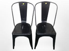 A pair of metal stacking chairs.