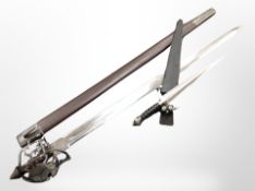 A reproduction basket-hilted sword in scabbard, and a further medieval-style dagger.