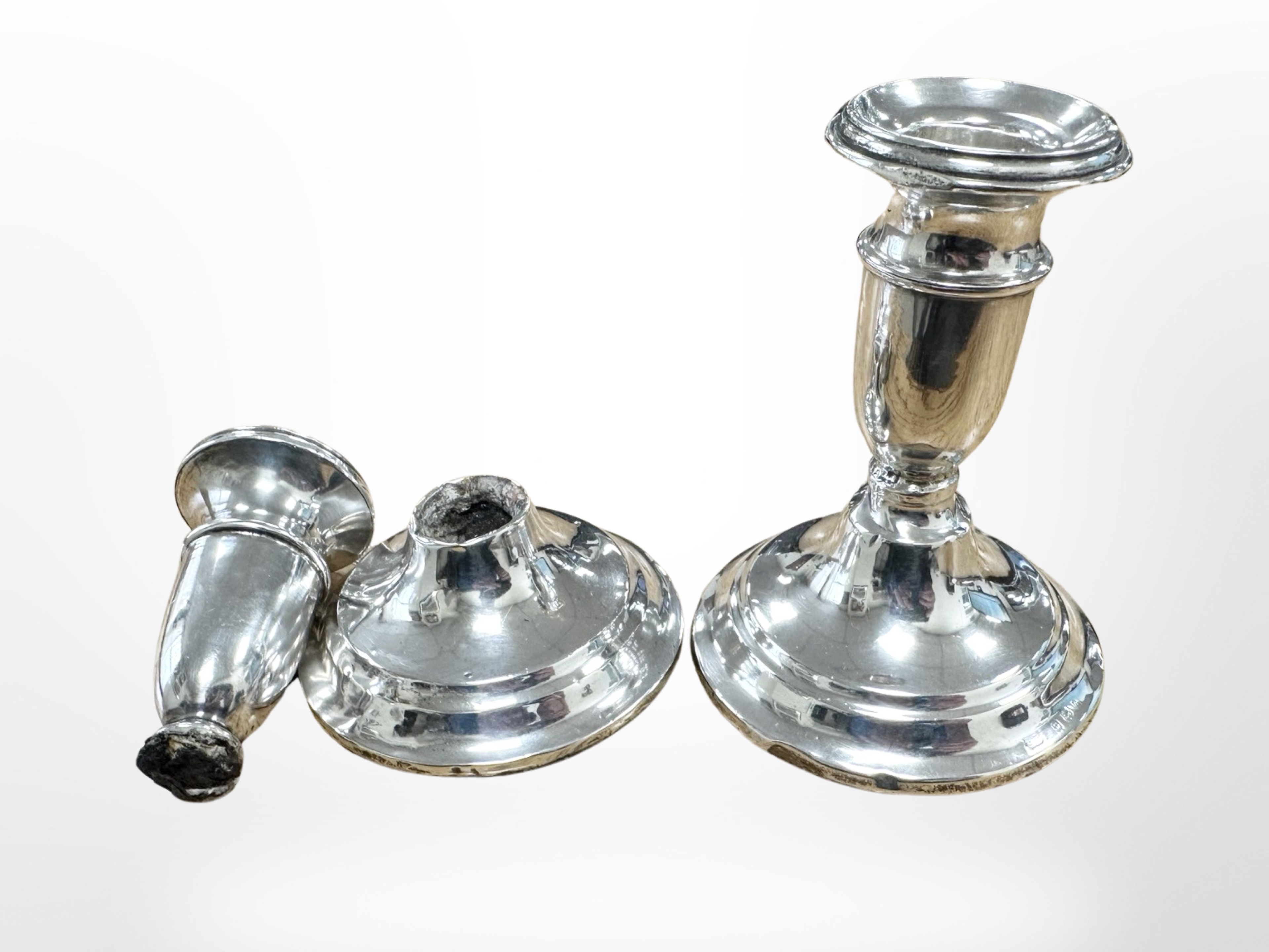 A pair of loaded silver dwarf candlesticks,