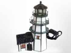 A Tiffany-style table lamp in the form of a lighthouse, height 24cm.