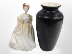 A Royal Doulton figure, 'Natalie' HN3173, and a Poole pottery vase, height 21cm.
