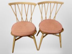 A pair of Ercol elm and beech spindle back dining chairs