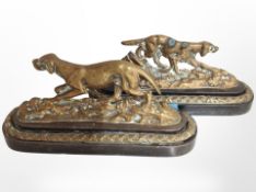 A pair of Victorian brass fireside dog ornaments, each 20cm wide.