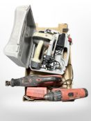 A box containing Performance circular saw, Hilti drill, and further saw.
