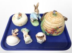 A Royal Winton biscuit jar in the form of a beehive, three Beswick Beatrix Potter figures,