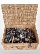 A wicker hamper containing a large quantity of costume bead necklaces, bangles,