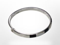 A silver bangle inlaid with onyx and mother of pearl, inner diameter 6cm.