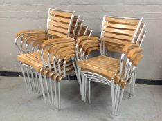 Nine oak and metal framed stacking chairs