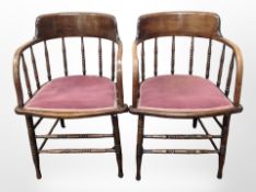 A pair of late Victorian carved oak spindle back armchairs