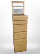 An oak effect slim chest with lift-up mirrored top,