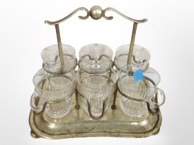 A silver-plated stand containing a set of six glass cups.