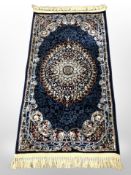 A machine made Turkish rug on blue ground,