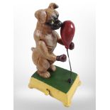 A novelty cast-iron Boxer dog with punch bag, height 18cm.
