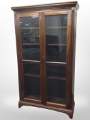 A 20th century mahogany glazed double door bookcase,