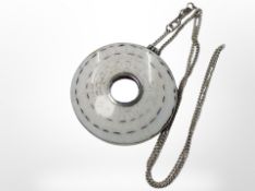 A silver polished shell pendant on chain, pendant 4.5cm diameter.