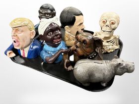 Seven novelty cast-iron money boxes.